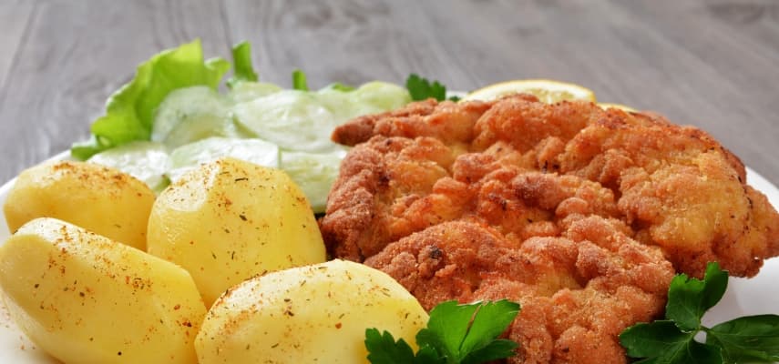 Kotlet schabowy with mashed potatoes and mizeria, the breaded Polish pork cutlet that anchors Sunday dinner tables across the country.